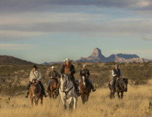 Riders in front of mountains Rancho de la Osa