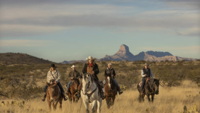 Riders in front of mountains Rancho de la Osa