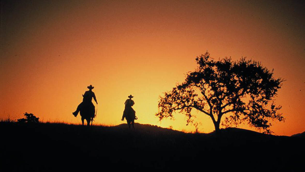 Two riders at sunset at Alisal Guest Ranch