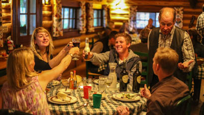 Family cheers at dinner at CM Ranch