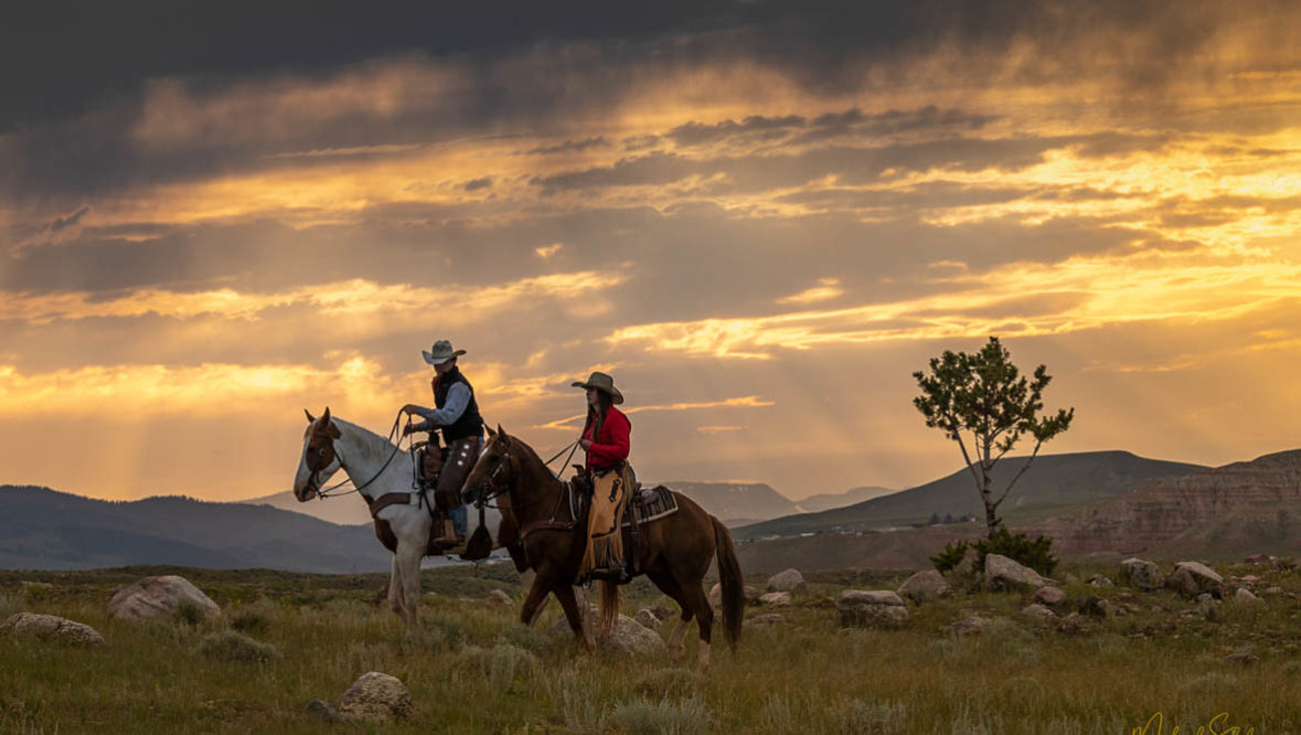 Two riders at dawn at CM Ranch