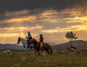 Two riders at dawn at CM Ranch