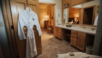 Cabin bathroom with robe at Lost Valley Ranch