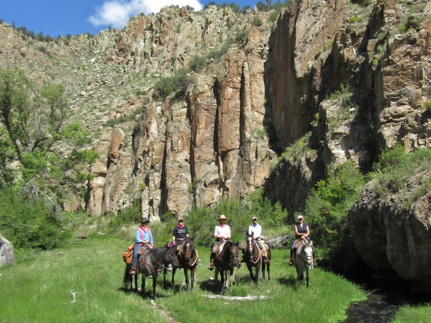 group of women on horses in canyon