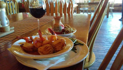 Dinner plate with a glass of wine at Goosewing Ranch