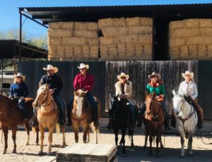 group of riders with cowboy hats lined up