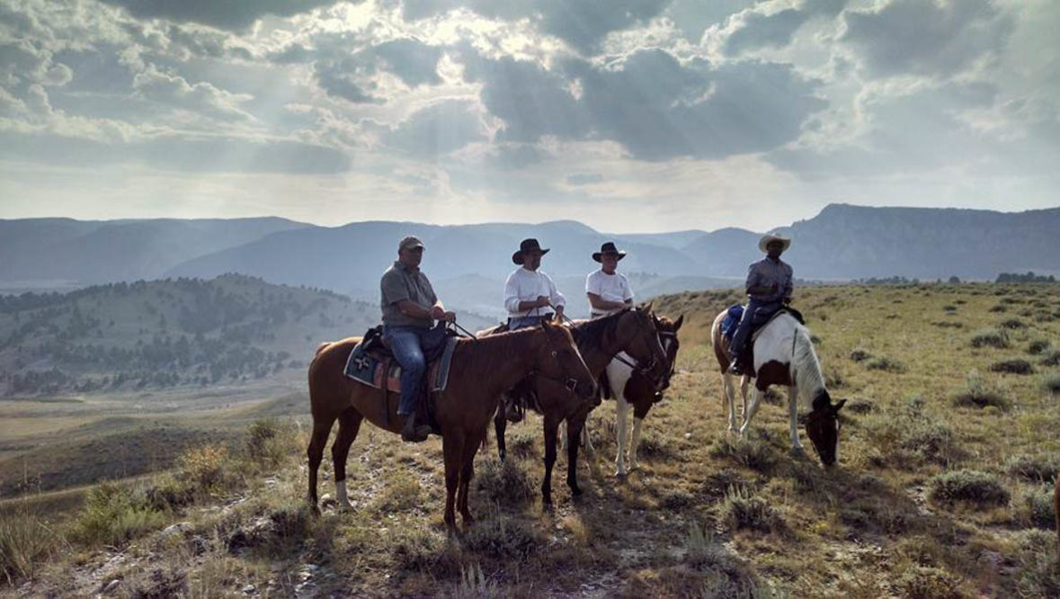 Guests looking at the view on a trail ride at Klondike Ranch