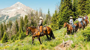 A family riding horses on the Lone Mountain trail