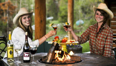 Two woman cheers wine at Triangle C Ranch