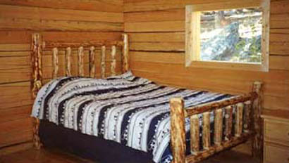 Bed in cabin at Allens Diamond 4 Ranch