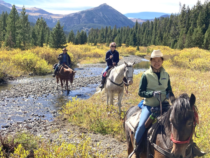 Riders crossing a creek at Hawley Mountain Guest Ranch