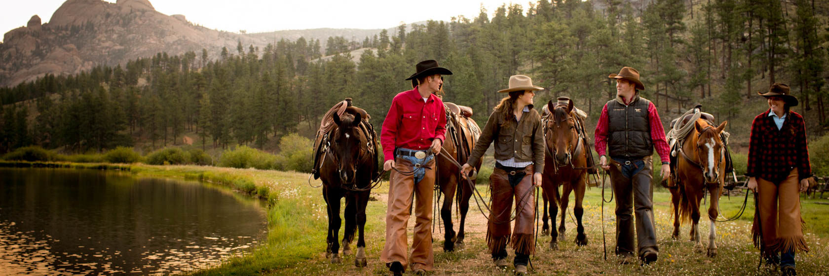 Lost Valley wranglers walking by a lake