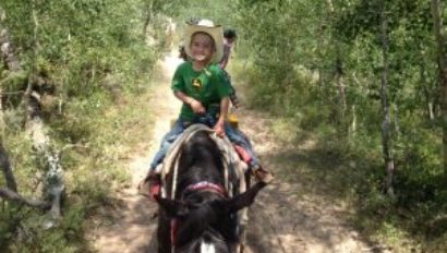 kid on a horse trail