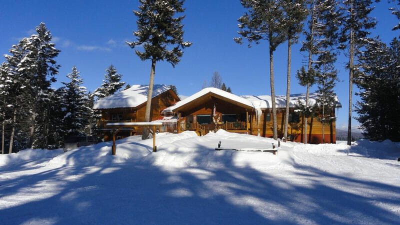 Rich's Montana Guest Ranch snow covered ground and cabin