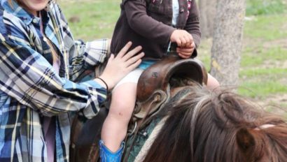 toddler riding a pony