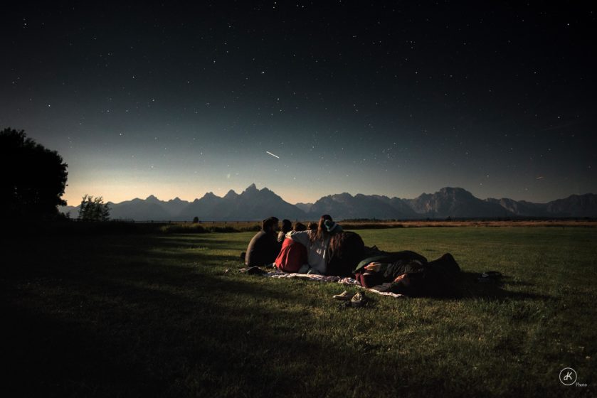 People on a blanket under a starry sky