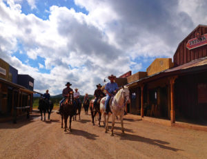 Tombstone Monument Ranch horses riding down street at ranch