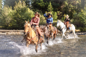 3 riders crossing Shoshone Lodge river