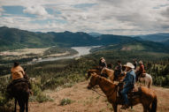 Riders on a hill overlooking river