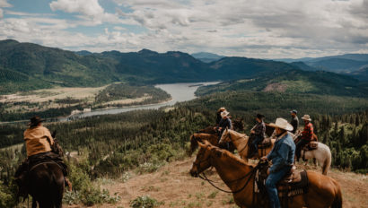 Riders on a hill overlooking river