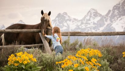 girl petting horse at Lost Creek
