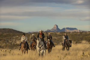 Riders in front of mountains Rancho de la Osa