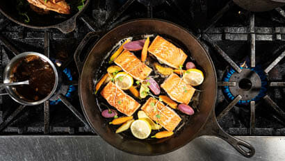 Salmon in a cast iron pan on the stove at 4UR Ranch