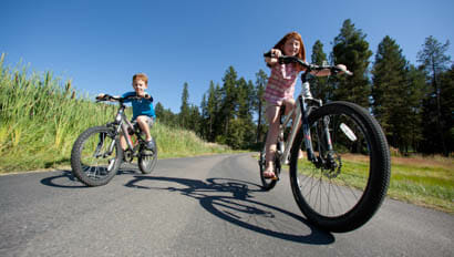 Two kids riding bikes at Averills Ranch