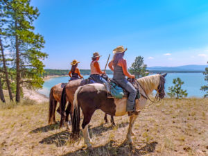 3 riders looking out over water