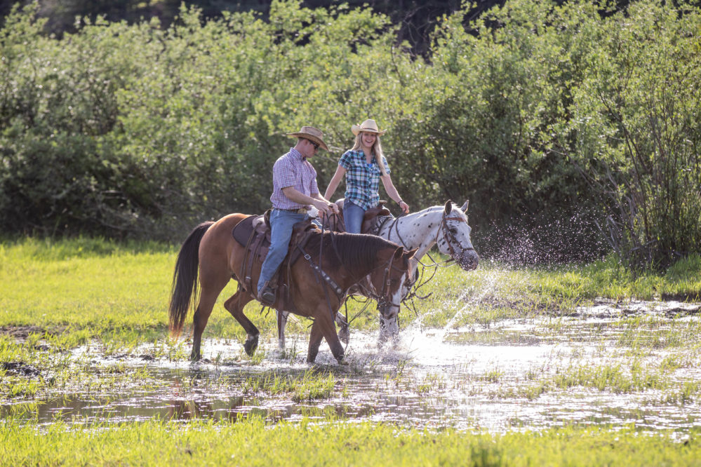Western Pleasure Guest Ranch two riders in water riding green