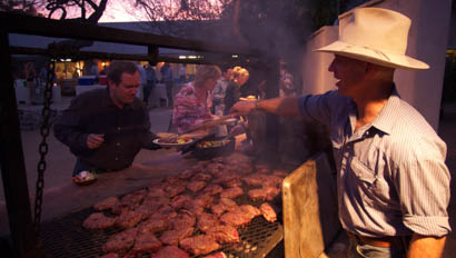 Staff member grilling meat at Elkhorn Ranch Arizona
