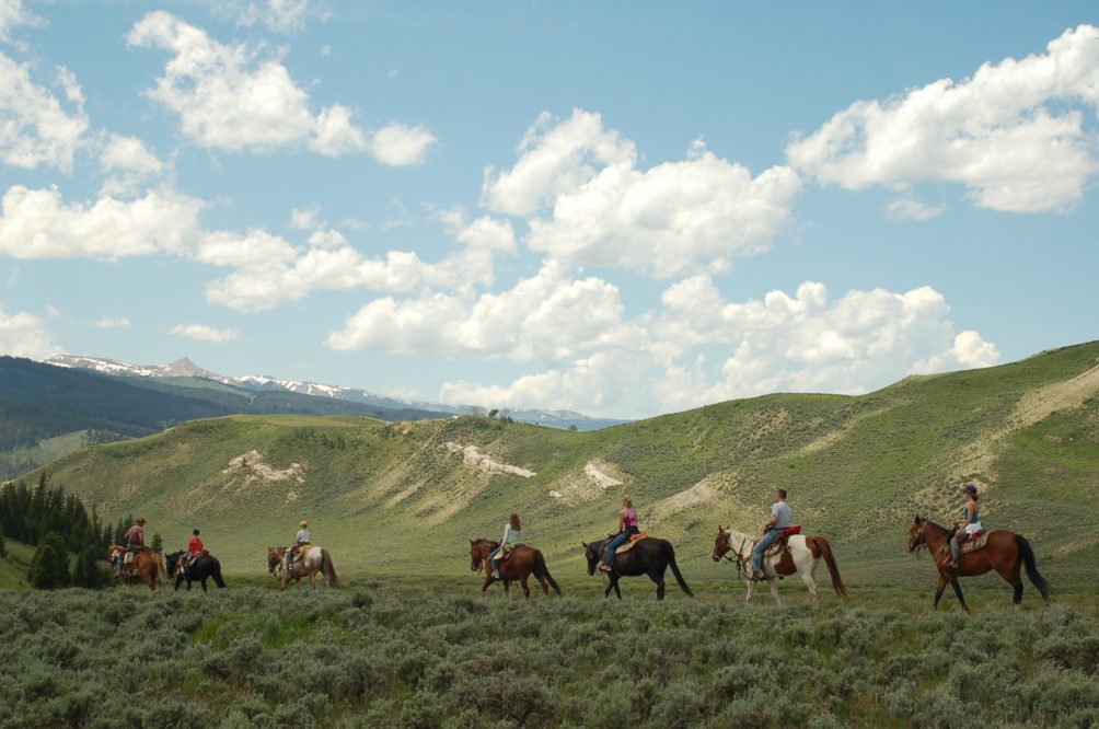 trail ride on ridge with blue sky and clouds