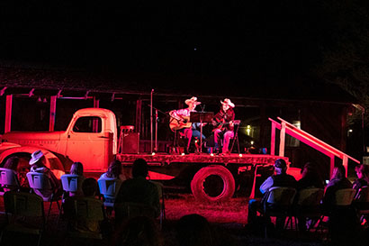 Hunewill Guest Ranch musical performance at night on back of old truck