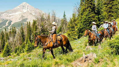 A family riding horses on the Lone Mountain trail
