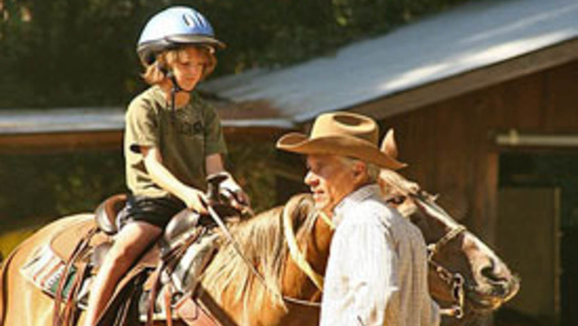 Grandparents with child on a horse at Marble Mountain Ranch
