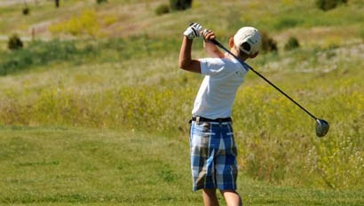 Kid playing golf at Mountain Sky Guest Ranch