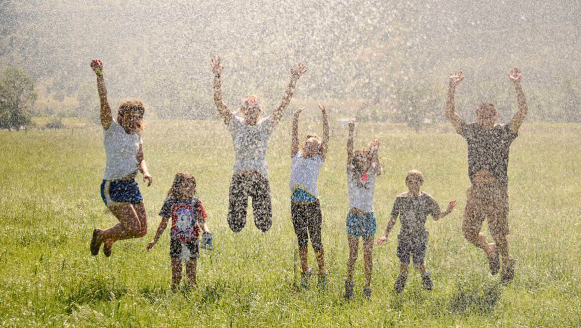 Kids jumping in the air at Mountain Sky Guest Ranch