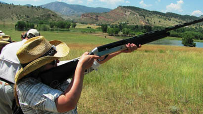 Sylvan Dale Ranch woman shooting a rifle