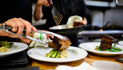 Chefs preparing a plate of food at Lost Creek Ranch