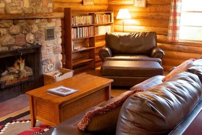couch and chair in log cabin