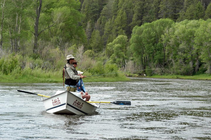 men on boat fly fishing