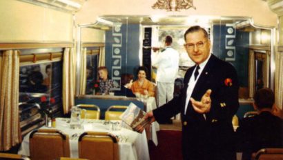 Server seating people on an old fashion train
