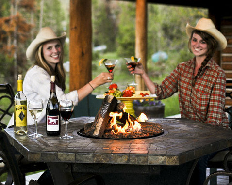 girls cheers-ing by fire with drinks