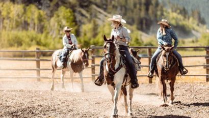 3 people riding horses